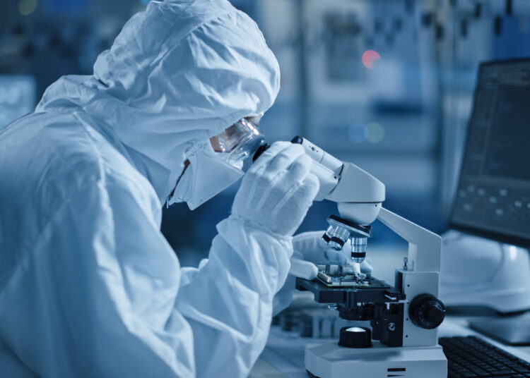 Research,Factory,Cleanroom:,Engineer,Scientist,Wearing,Coverall,,Gloves,Uses,Microscope
